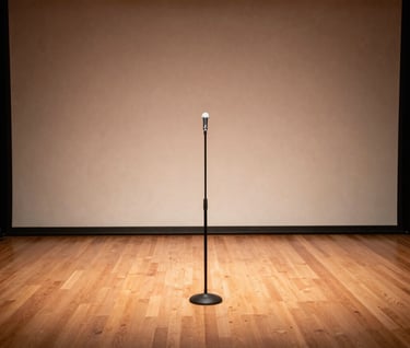A wide shot of an intimate stage in a North American / US jazz club. A single microphone stand and a Warm Taupe wooden floor are illuminated by a Soft Pearl Beige spotlight, capturing an atmosphere of creative passion.
