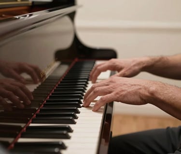 Close-up photography of a North American / US musician's hands playing a Dark Charcoal Brown piano. The setting is a professional studio with Soft Pearl Beige walls and natural, soft light, conveying timeless elegance.