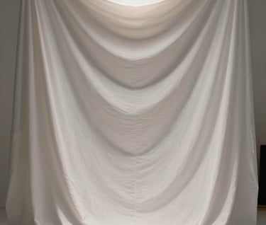 Symmetry and perspective on a high-end photography set, featuring white fabric drapes and a single golden spotlight, elegant and immersive atmosphere, Western European / French design aesthetic.