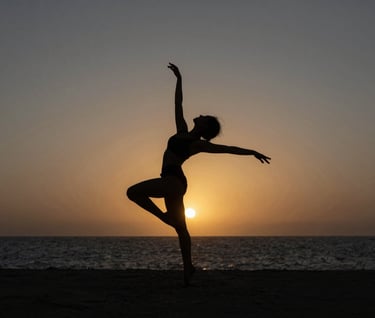 Still frame from a short film featuring a silhouette of a dancer against a sunset in a Angolana coastal landscape, charcoal slate grey horizon, antique burnished gold sun, high contrast photography.