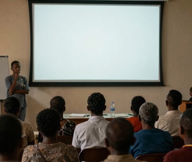 An emotional scene in an Angolana community center where people are watching a documentary, their faces lit by the soft off-white glow of the screen, dark charcoal black shadows.