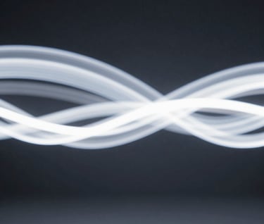 An abstract, long-exposure shot of light trails in a dark room, creating ethereal white ribbons of movement against a solid #0A0A0C background.
