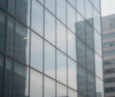 Abstract close-up of light reflecting off a glass facade. Distorted urban patterns in #F5F7FA and #D0D5DB, minimalist and contemporary framing.