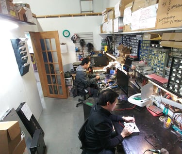a man working on a computer in a room