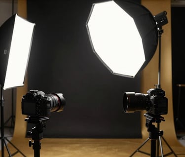 A behind-the-scenes professional photography studio setup in Kartal, Istanbul. High-end cameras and softbox lighting against a deep black and elegant gold backdrop.