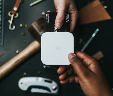 a person holding a small square shaped object