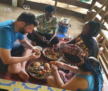 Tourists learning and experiencing traditional Zanzibar cooking techniques from local villagers 