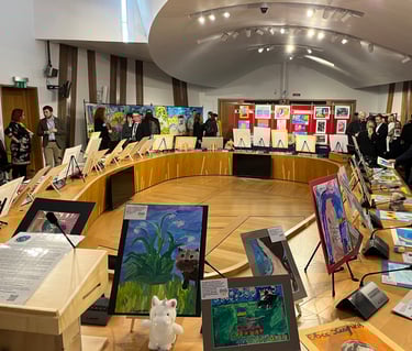 Politicians looking at the exposition with paintings created by children in the Ukrainian war