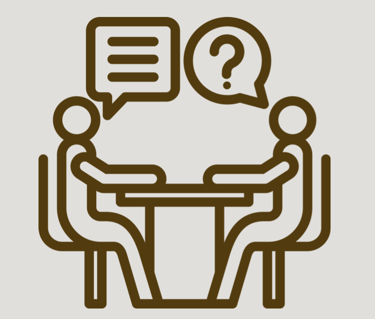 Picture of OT and participant at a table learning asking questions and learning together