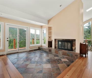 Custom wood and stone tile floors with windows and Montana nature outside.