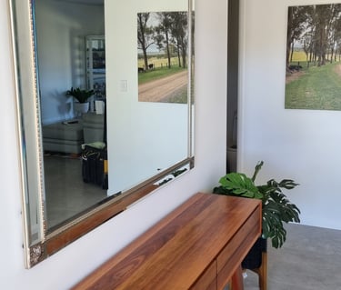 square mirror in entrance above table