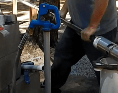 Technician about to snake the well pump into the well
