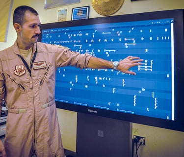 Captain (now Lt Col) Gary Olkowski showing how the Jigsaw application works on a large touch monitor