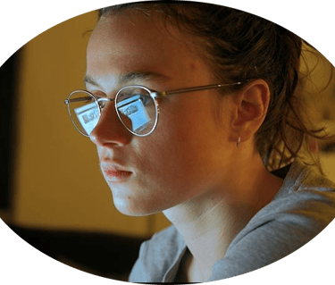 a woman in glasses and a gray shirt