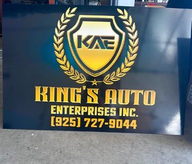 King's Auto Enterprises Inc. custom black sign with gold 3D lettering and shield logo.