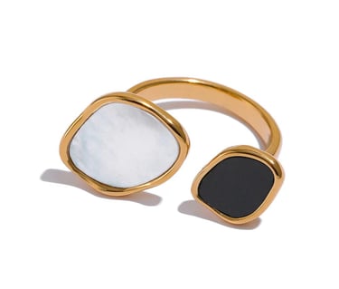 Gold open ring featuring organic shaped white shell and black onyx stone accents.