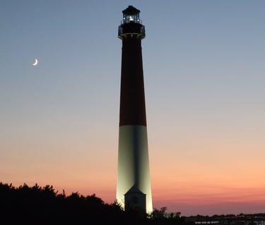 Picture of Barnegat Light House  at sunset with a crescent moon