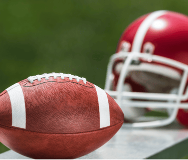 a football helmet and a football ball on a bench