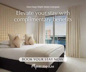 Luxury hotel room at Hard Days Night Hotel Liverpool featuring a large bed and balcony view.