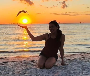 Laura Stella Life coach silhoutte on a beach sunset happy after overcoming burnout