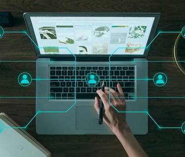 Hand on laptop keyboard with digital network icons representing social media connections and remote collaboration.