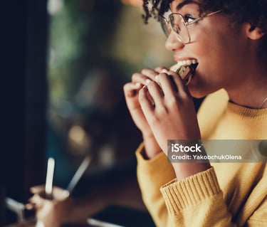 a woman eating a sandwich in a restaurant