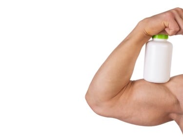 a muscular arm holding a bottle