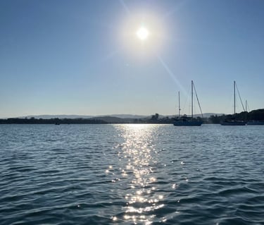 a boat in the water with the sun shining
