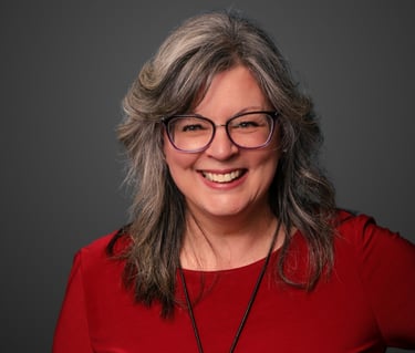 a woman with glasses and a red shirt
