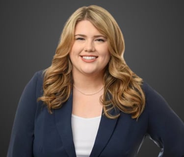 a blond woman in a blue jacket and white top