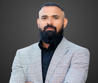 a man with a beard and grey suit