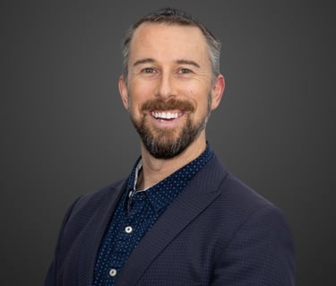 a man with a beard and navy suit