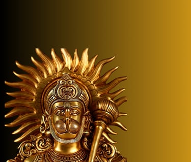 a brass statue of a hanuman with a sword