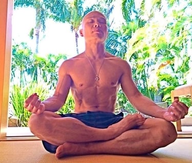JEET KUNE DO BUDDHA sitting in a meditation position on a yoga mat.
