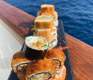 Sushi plated in rock dish with sea as background