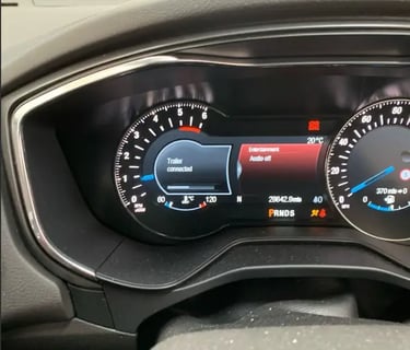 car dashboard display showing towing indicator
