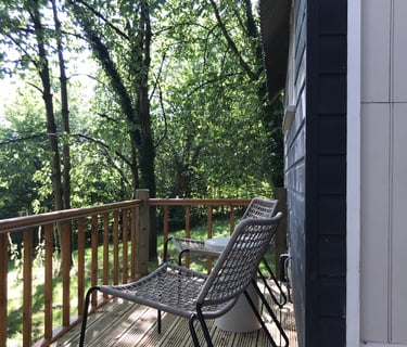 Relax on the balcony at Tom's Hut.