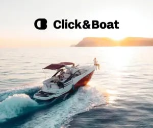 Luxury motorboat cruising on calm ocean waters during sunset for Click and Boat rental services.