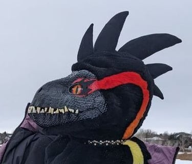 A incorporator fursuit Dino mask made by Teto Creations Featuriong a line of horns, 3d printed eyes and a painted gradient
