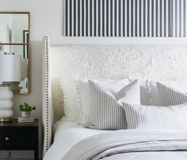 a bedroom with a bed and a mirror