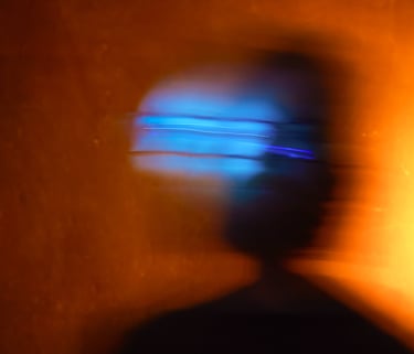 a person with a cell phone in front of a laptop
