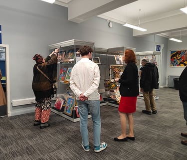 People looking at the display of Ukrainian children's paintings