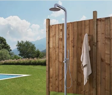 a shower with a shower head and a towel