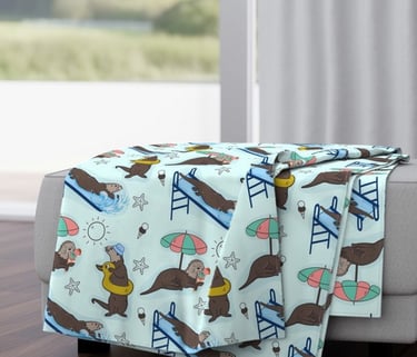 a couch with a sea otters blanket on it