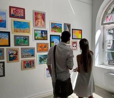 People admiring paintings made by children affected by war in Vienna