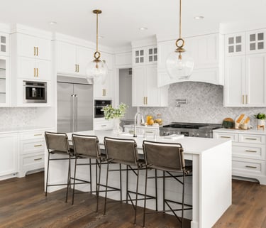 a kitchen with a large island and a bar stool