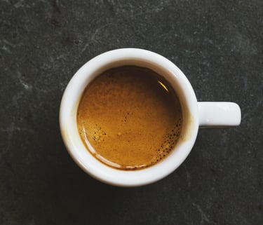 An espresso cup on top of a grey table
