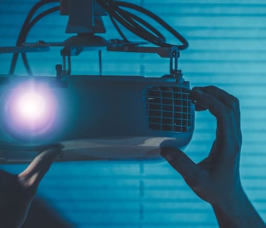 a person holding a projector with a projector light