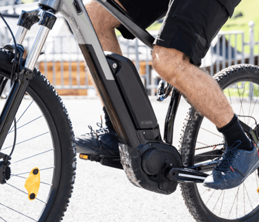 a man riding a bike with a bicycle in the background