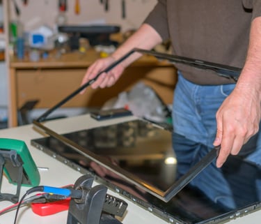 a man is holding a tablet computer and a tablet